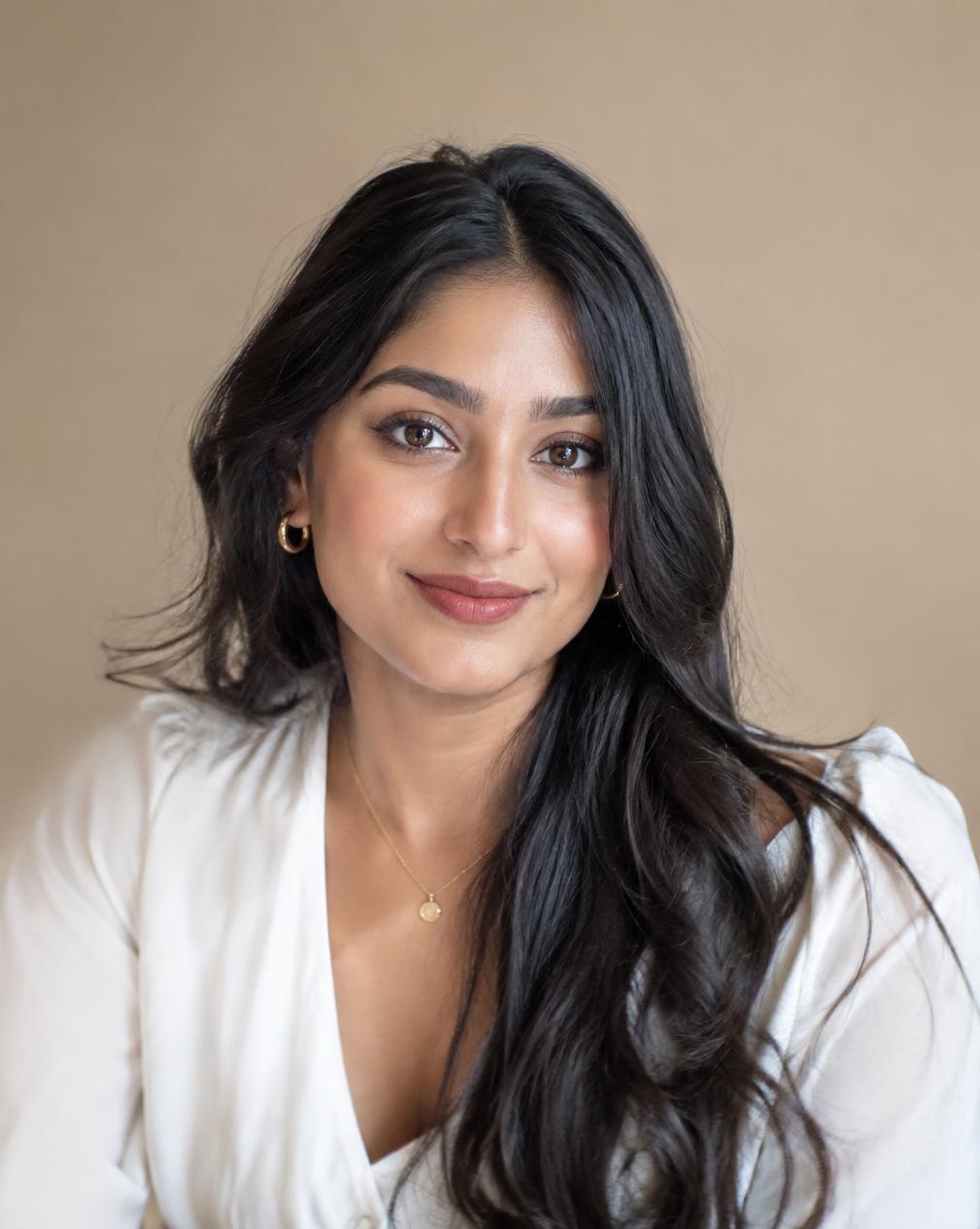 A personal branding headshot on a warm backdrop
