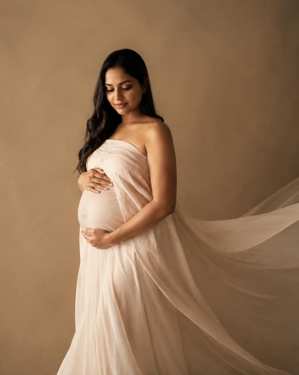A maternity portrait in soft studio light